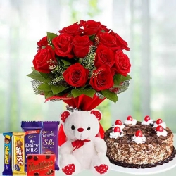 Adorable Bouquet of 12 Dutch Red Roses with 1 Lb Cake, Mixed Cadburys Chocolates and a Teddy Bear to Garia Adorable Bouquet of 12 Dutch Red Roses with 1 Lb Cake, Mixed Cadburys Chocolates and a Teddy Bear to Garia