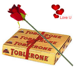 Toblerone Swiss make (200 gms) with One Velvet Red Rose Toblerone Swiss make (200 gms) with One Velvet Red Rose