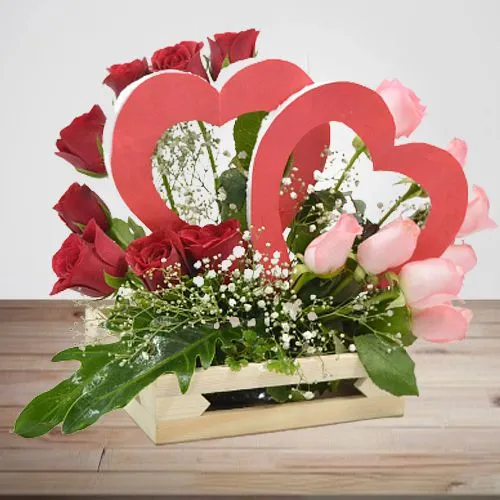 Elegant Basket Arrangement of Red  N  Pink Roses with Twin Heart Prop
