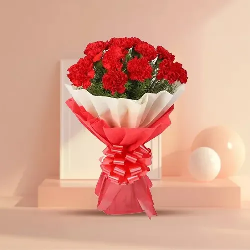 Now deliver this delicate Hand Bunch of Red Carnations in tissue