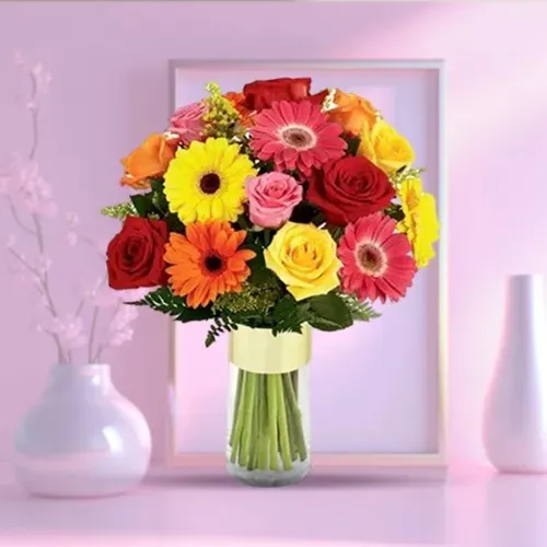 Enigmatic Gerberas N Roses display in a Glass Vase