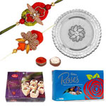 Beautiful Rakhi Combo With Soan Papdi, Cadbury Roses And Silver Puja Thali Beautiful Rakhi Combo With Soan Papdi, Cadbury Roses And Silver Puja Thali