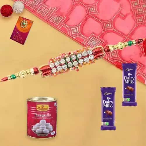 Two Dairy Milks (13gm) and Rasgulla with Rakhi and Roli Tilak Chawal Two Dairy Milks (13gm) and Rasgulla with Rakhi and Roli Tilak Chawal