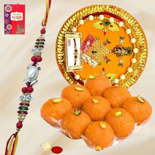 Laddoo and Designer Pooja Thali along Rakhi, Roli, Tilak and Chawal Laddoo and Designer Pooja Thali along Rakhi, Roli, Tilak and Chawal