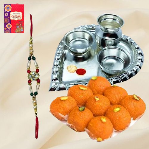 Laddoo and Stylish and Trendy looking Silver Plated Paan Shaped Puja Aarti Thali along Rakhi, Roli, Tilak and Chawal Laddoo and Stylish and Trendy looking Silver Plated Paan Shaped Puja Aarti Thali along Rakhi, Roli, Tilak and Chawal