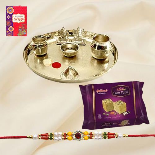 Soan Papri and Stylish and Trendy looking Silver Plated Paan Shaped Puja Aarti Thali along Rakhi, Roli, Tilak and Chawal Soan Papri and Stylish and Trendy looking Silver Plated Paan Shaped Puja Aarti Thali along Rakhi, Roli, Tilak and Chawal
