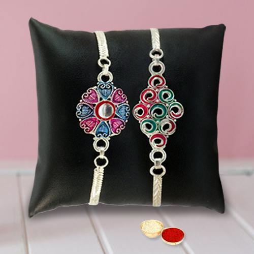 An Elegant Silver Plated Twin Rakhi set with Roli Tilak and Chawal An Elegant Silver Plated Twin Rakhi set with Roli Tilak and Chawal