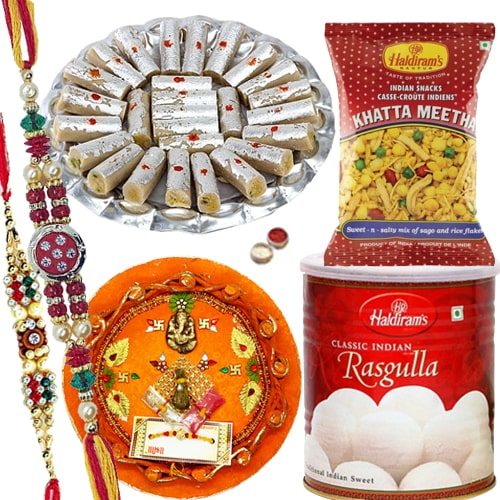 Rakhi Thali with Rakhis, Haldirams Rasgulla, Kaju Pista Roll n Chanachur<br><font color=#0000FF>Free Delivery in USA</font> Rakhi Thali with Rakhis, Haldirams Rasgulla, Kaju Pista Roll n Chanachur<br><font color=#0000FF>Free Delivery in USA</font>